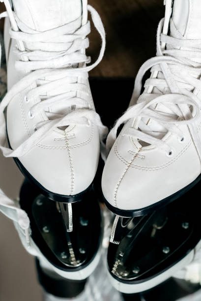 istock Female white ice skating boots with untied shoelaces 1413234105