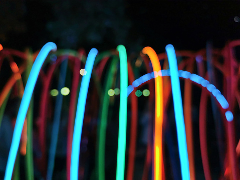 Defocused abtract blurred artistic multicolour light stripes in dark background