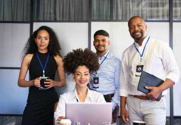 istock Confident, powerful and diverse team of creative colleagues with laptop and technology ready for meeting, brainstorming and planning ideas in office. Portrait of executive men and women feeling proud 1413236990