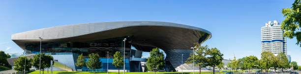 The BMW Wold in Munich On August 4th 2022, the BMW world in Munich where cars are sold, made, exhibit and planned. The site has a car dealer, an exhibition room, a museum, a assembly plant and a tower for workers offices. bmw dealership stock pictures, royalty-free photos & images