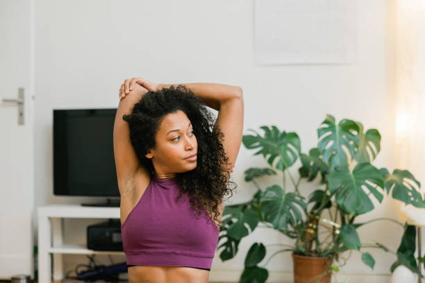 istock Fit woman doing stretching workout at home 1413238654