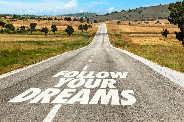 istock Follow Your Dreams Written on Road 1413239586