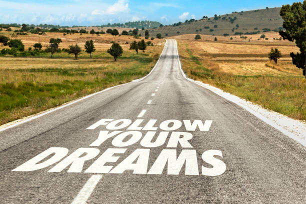 Follow Your Dreams Written on Road stock photo