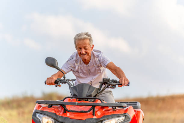 istock senior man driving quad bike 1413241374
