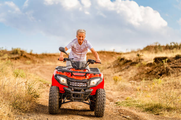 senior man driving quad bike
