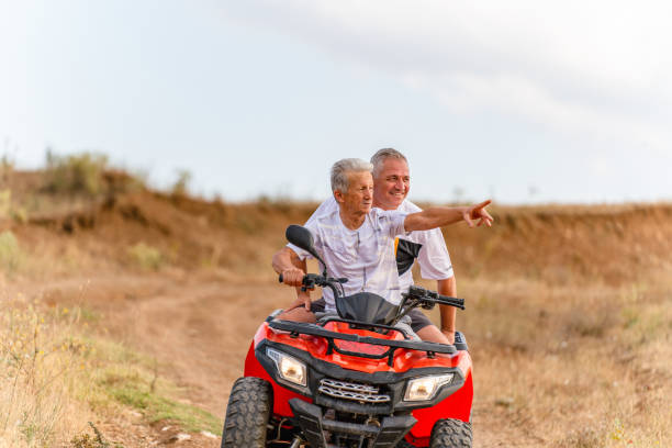 istock father and his  son  on an ATV quad biking 1413242526