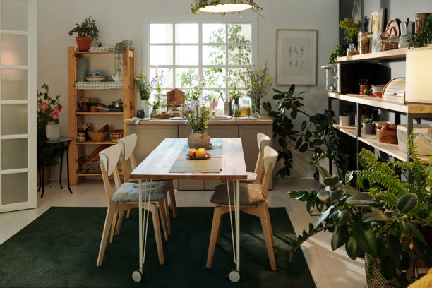 istock Interior of cozy kitchen in modern apartment with table and chairs on carpet 1413244317