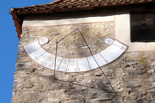 Close-up of the sundial on the wall of an old chapel on the Moritzberg in Germany on a sunny february day.