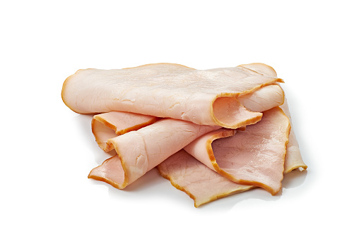 Thin smoked ham slices on white background