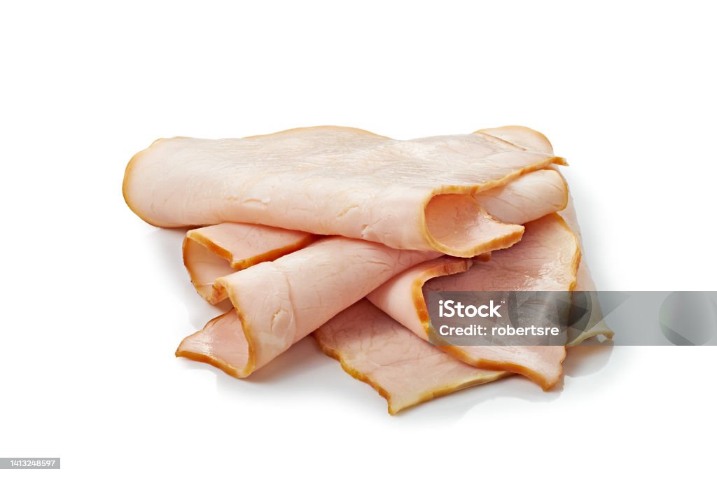Thin smoked ham slices on white background Thin smoked ham slices isolated on white background. Clipping path included Turkey Meat Stock Photo