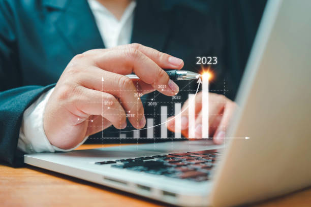 istock Businessman using computer analyzes profitability of working companies with digital augmented reality graphics,positive indicators in 2023,business calculates financial data for long-term investments. 1413248741