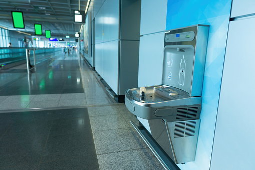 Sensor activated bottle refilling station at the airport terminal
