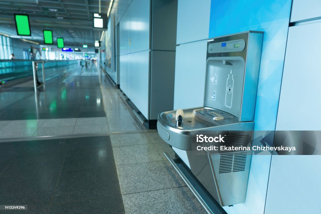 Sensor activated bottle filling station at airport Sensor activated bottle refilling station at the airport terminal Water Stock Photo