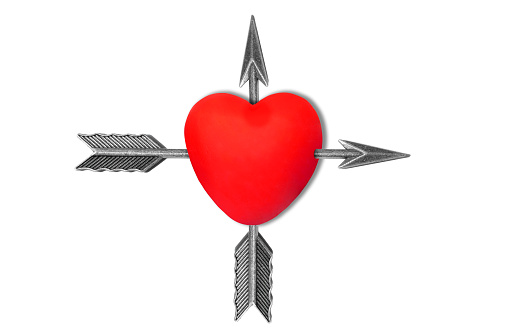 Large red heart shape pierced by two feathered arrows in cross direction isolated on white background.