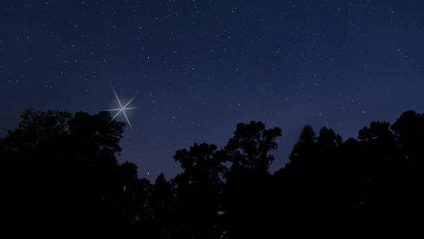 istock Christmas star rising from the dark 1413249704