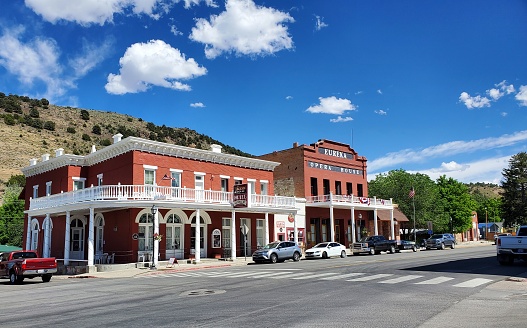 Eureka, Nevada, USA-June 29, 2021:A section of Main Street and historic buildings in Eureka, Nevada in mid afternoon on a bright sunny day. Parked cars and trucks but no one moving around.