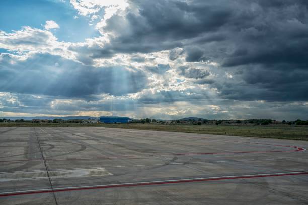 istock Clouds over airport of Valencia. Sun rays 1413251500