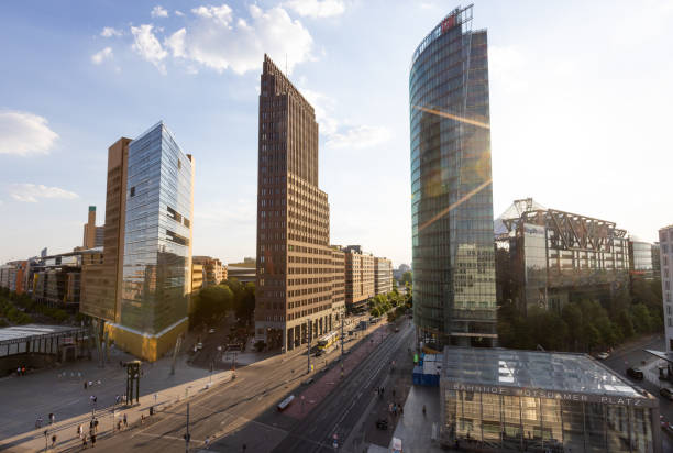 Potsdamer Platz with office buildings along the road. Tall buildings along the street in the city on a sunny day.