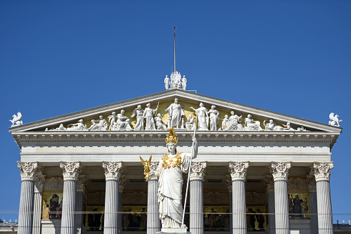 The Neo-Classic temple of parliament government in Vienna, Austria with the statue of Athena in gold helmet
