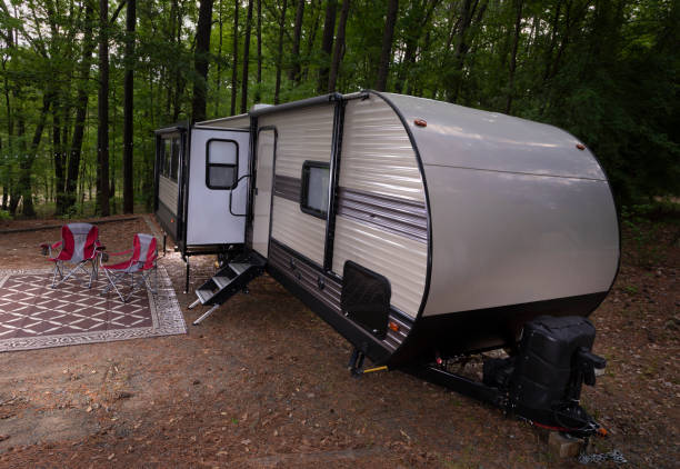 istock Two red chairs wating at a camper trailer 1413254110