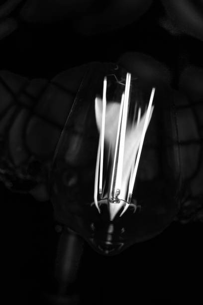 istock Abstract shape and patterns of light bulb filaments in darkness 1413256462