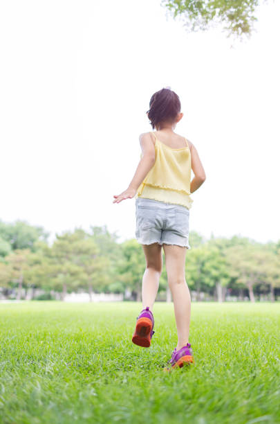 Little Girl Running on the Grass
