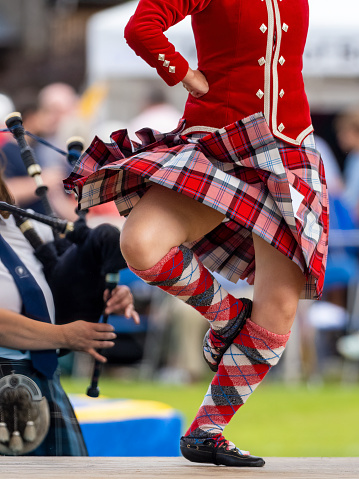 Dufftown, Scotland, UK - July 30, 2022: A Highland Dancer performing at the Highland Games in Dufftown, Scotland.  Highland games are a part of Scottish culture and a popular day out for both tourists and local people alike during the summer.