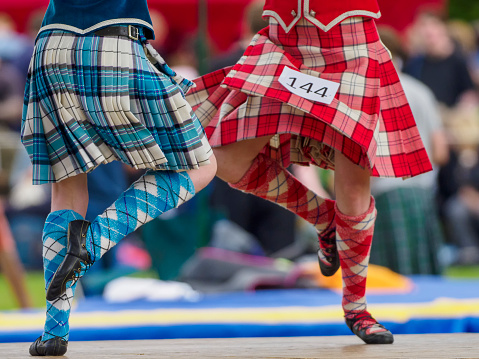 Dufftown, Scotland, UK - July 30, 2022: Two Highland Dancers performing at the Highland Games in Dufftown, Scotland.  Highland games are a part of Scottish culture and a popular day out for both tourists and local people alike during the summer.