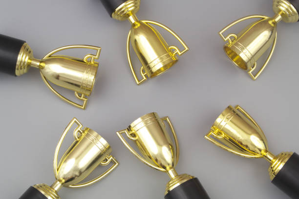 istock Many gold champion trophy cups on gray 1413258742