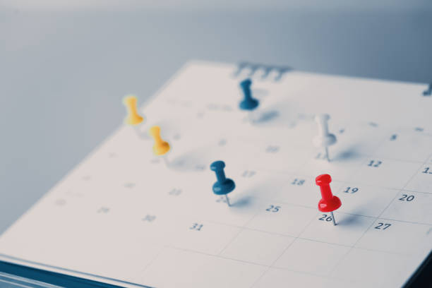 istock Embroidered red pins on a calendar event Planner calendar,clock to set timetable organize schedule,planning for business meeting or travel planning concept. 1413259280