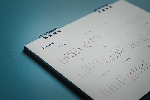 2023 May calendar on a white note paper pinned on wall against blue background. High resolution and copy space for all your crop needs.