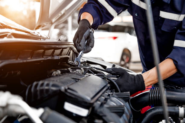 istock Car care maintenance and servicing, Close-up hand technician auto mechanic using the wrench to repairing change spare part car engine problem and insurance service support. 1413259857
