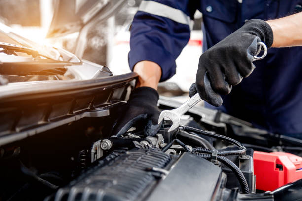 istock Car care maintenance and servicing, Close-up hand technician auto mechanic using the wrench to repairing change spare part car engine problem and insurance service support. 1413259859