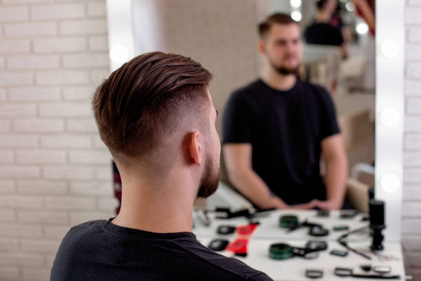 Male head with stylish haircut Male head with stylish haircut on barbershop background half shaved hairstyle stock pictures, royalty-free photos & images