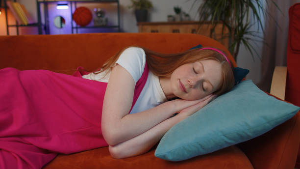 istock Tired one child girl kid lying down in bed taking a rest at home, napping, falling asleep on sofa 1413260690