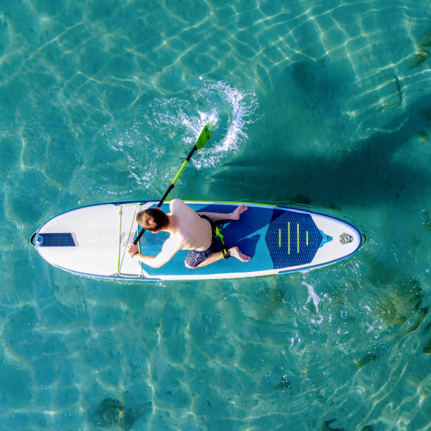 istock Young man on a paddleboard on the sea in summer 1413260707