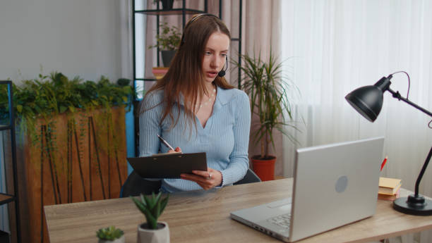 istock Young woman freelancer wearing headset, call center or support service operator helpline having talk 1413260842
