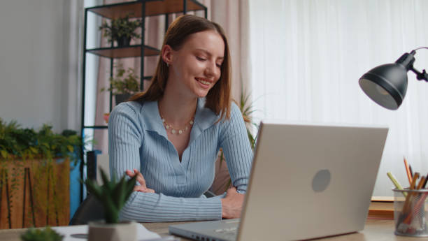 istock Young woman freelancer at home office making laptop video call chat conversation, working online 1413260844