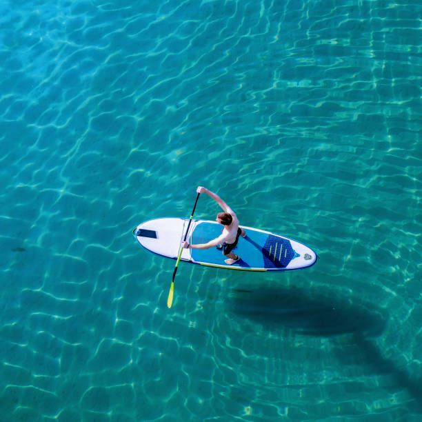 istock Young man on a paddleboard on the sea in summer 1413261706
