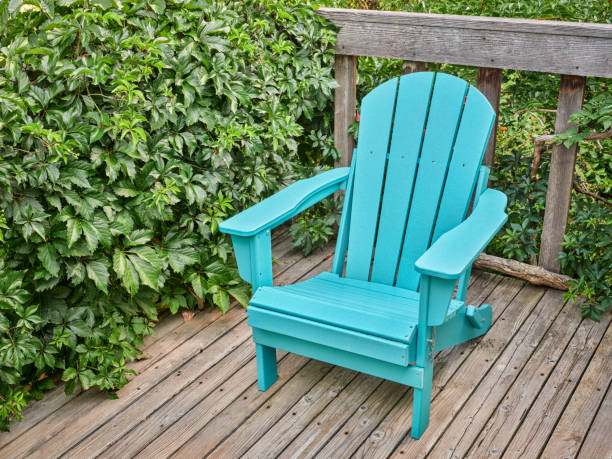 istock empty Adirondack chair on a wooden backyard dec 1413264530
