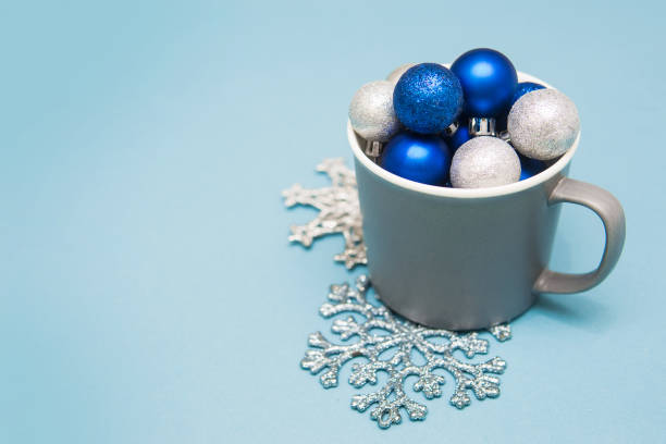 blue and silver christmas balls in a cup on a blue background. creative concept of christmas and new year. - decor christmas celebration event christmas ornament imagens e fotografias de stock