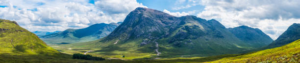 Scotland sunlight and shadows on Glen Coe Highlands mountains panorama Panoramic view from the Devil’s Staircase on the West Highland Way over the green valley of Glen Coe to Buachaille Etive Mor and the Highlands of Scotland, UK. glen etive photos stock pictures, royalty-free photos & images