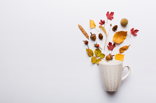 Autumn composition with cup and dried leaves on table. Flat lay, top view, copy space.