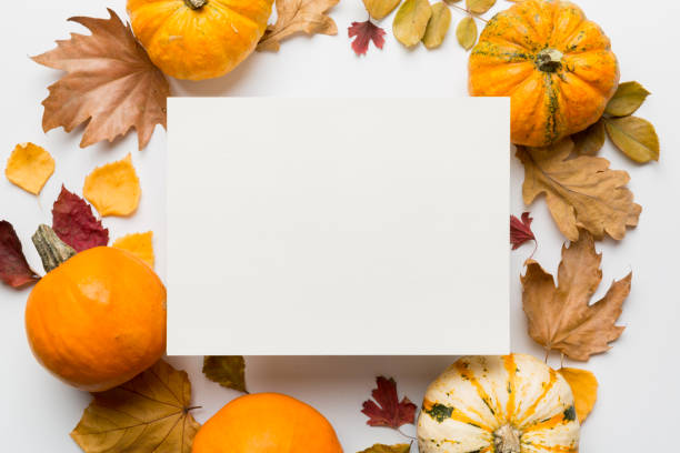 istock Autumn composition with paper blank and dried leaves with pumpkin on table. Flat lay, top view, copy space 1413268569