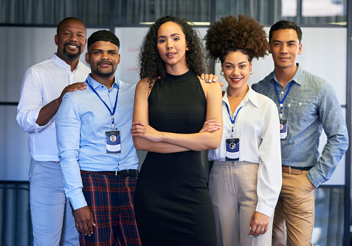 Manager, leader and boss leading diverse team of creative marketing men and women in office. Portrait of confident, assertive or proud ceo with arms crossed ready for success with group of colleagues