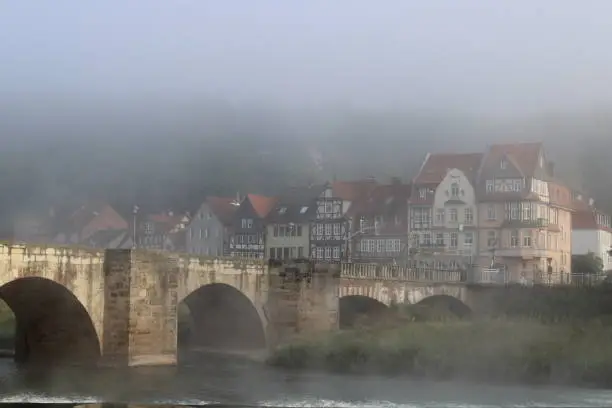 Photo of Bridge over the Weser river and residential buildings in Hannoversch Münden