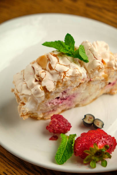istock Cake with meringue roll with cream and raspberries 1413270164
