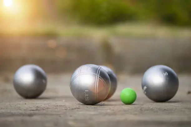 Petanque balls in the playing field with shady as a backdrop.