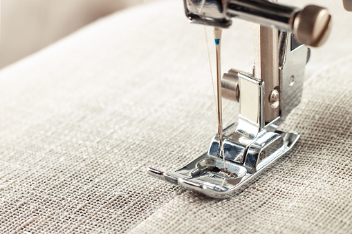 Cropped shot of an unrecognizable woman doing embroidery at home