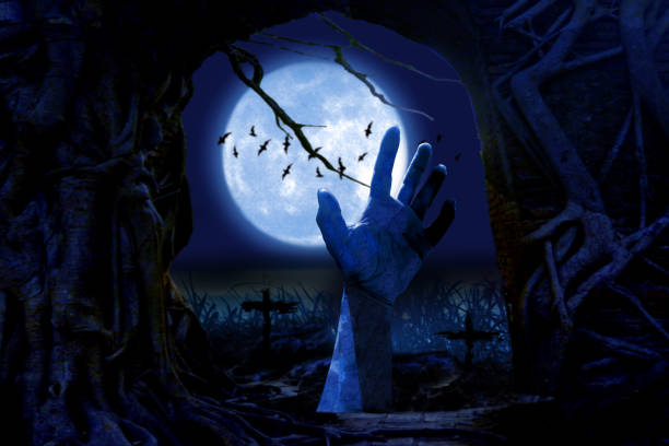 istock Zombie hands rising in dark Halloween night. 1413272239